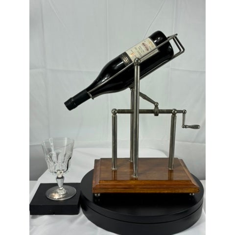 A striking and functional wine service accessory, this vintage mechanical wine presentation stand elevates the ritual of...