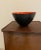 A wonderful Danish mid century bowl with red enamel interior and dark gray exterior. Circa 1950s.
