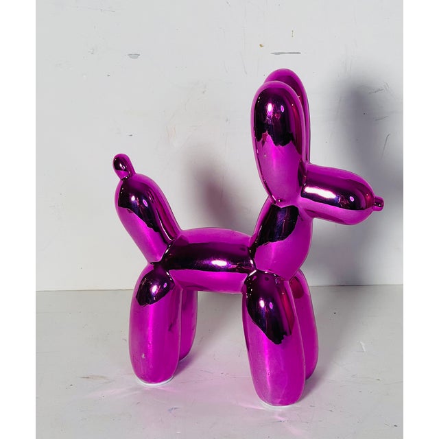 Modern sculpture of ceramic purple balloon dog.