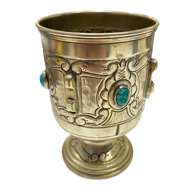 A striking vintage alpaca silver (nickel silver) goblet richly adorned with repoussé floral and foliate motifs and set...
