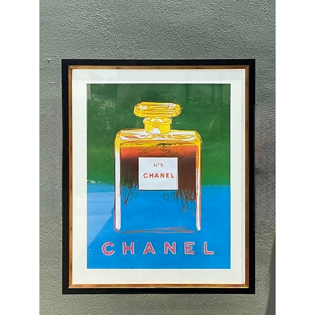 This striking framed advertising poster is a vibrant homage to the legendary collaboration between the House of Chanel and...