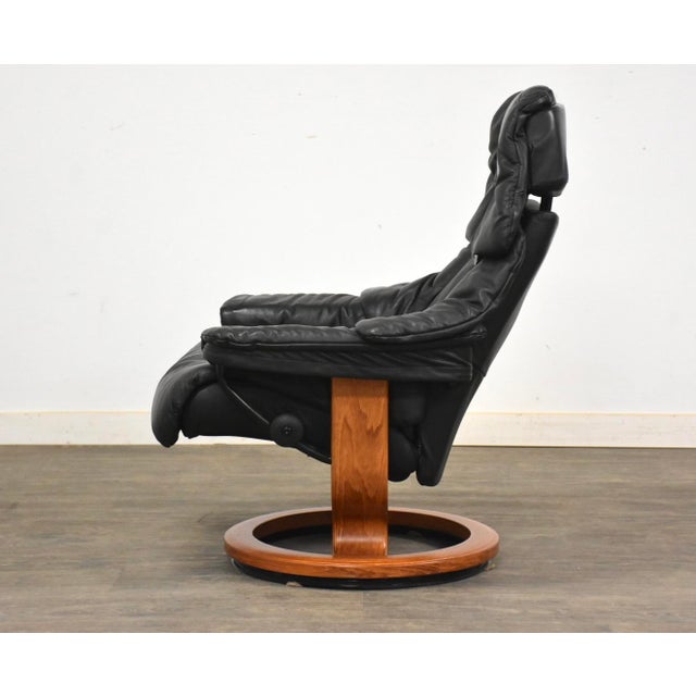 A black leather Stressless Recliner lounge chair in a soft black leather made by Ekornes with a teak base. Made in Norway....