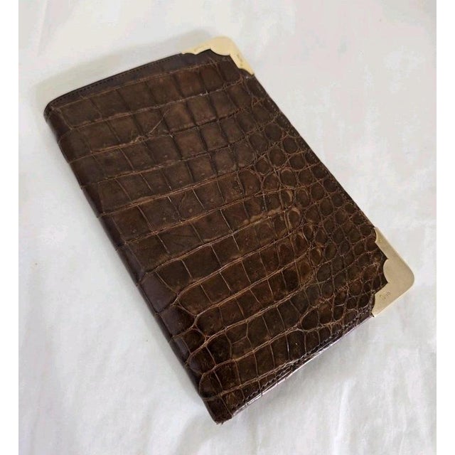A fine george v gentleman’s wallet dating to 1923, crafted from luxurious crocodile skin with a finely finished kid...