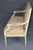 This is a charming French Louis XVI–style painted settee, dating approximately to the 1930s–1940s. The elegant two-seat...