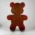 A lovely large handmade teddybear made of heavy solid wood and standing on four metal wheels. It's a combination of brown...