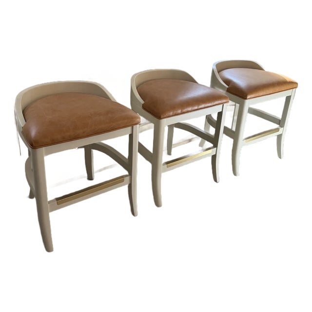 Custom Counter Stools by Jessica Charles — Toffee Leather, Antique White Frame, Brass Footrest (Set of 3) For Sale