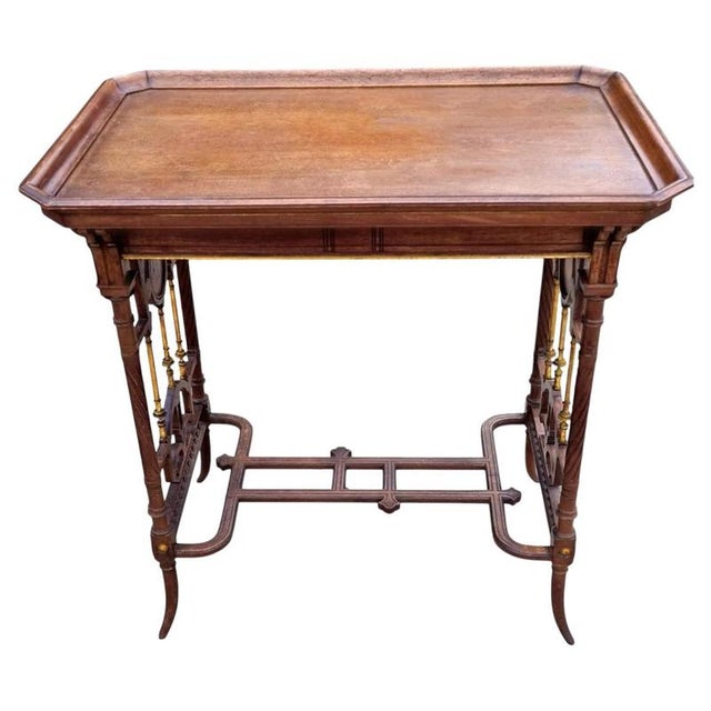 A decorative English side table dating to circa 1885 and designed in the Aesthetic Movement tradition. Constructed...
