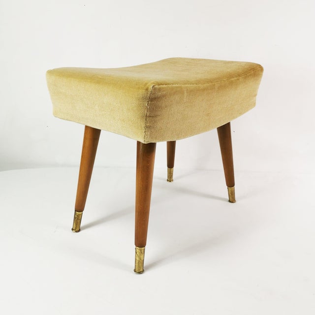 This stool/pouffe, from Germany, 1960s, is characterized by a spacious, modernist Mid-Century design. It is made of beech...