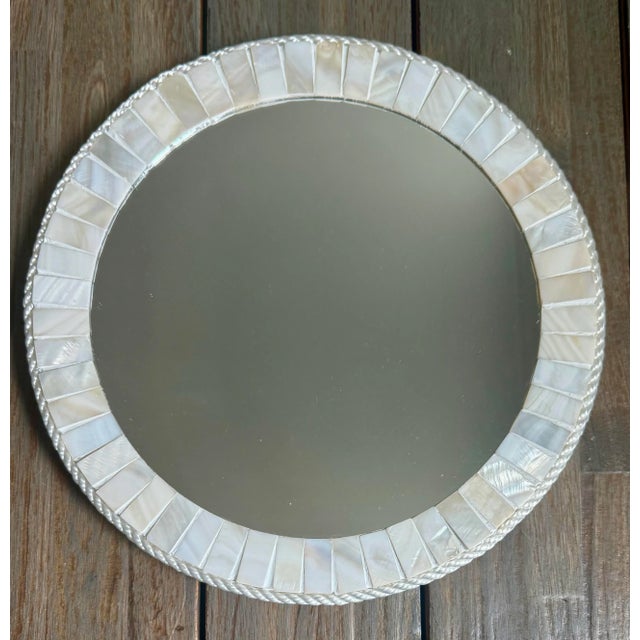 This handmade unique round mirror, framed with genuine mother of pearl will elevate any space. The iridescent shimmer of...