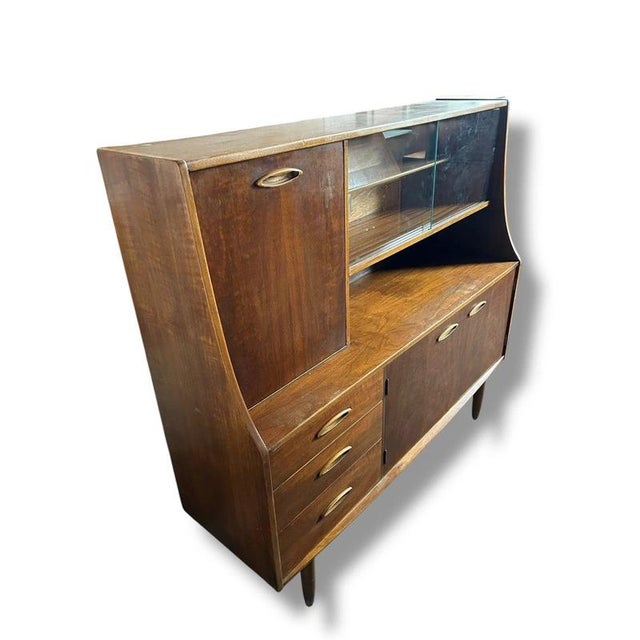 This mid century sideboard offers a perfect blend of style and function, crafted from rich teak wood to elevate your...