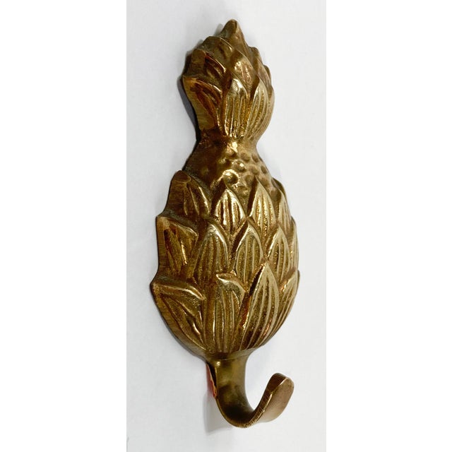 Vintage brass detailed pineapple motif wall hook. Nice patina.