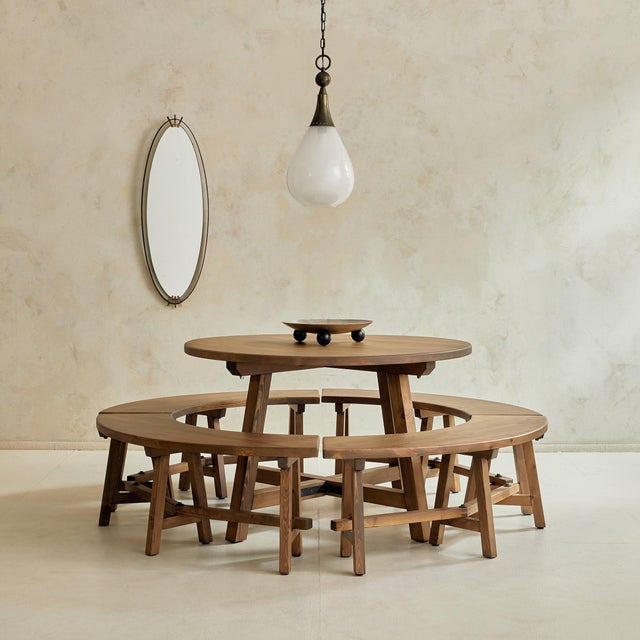 A rare French dining set from the 1950s, composed of a round table and four curved benches that encircle it in harmonious...