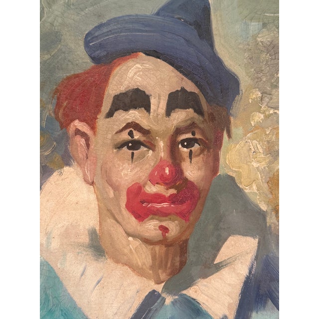 Signed original oil painting portrait on canvas of a somber circus clown in blue. Circa 1960s. The painting features...