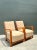 Distinguished by their sweeping modernist profiles, this pair of vintage Art Deco lounge chairs features elegantly curved...