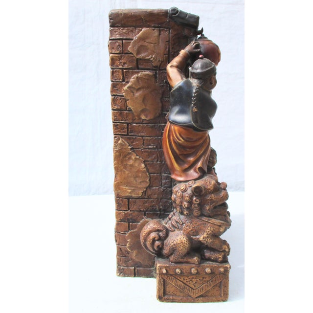 Absolutely charming vignette of two boys putting up lanterns at a doorway. Obviously Chinese door with guardian foo lions...