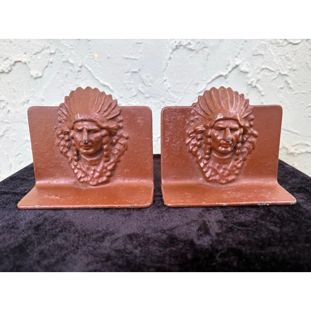 This striking pair of vintage bookends features a sculptural Native American profile in high relief, rendered in a warm...