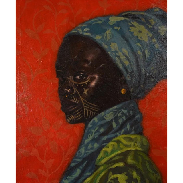 A dignified African woman in vibrant fabrics and traditional facial markings - a celebration of heritage. Pairs with "My...