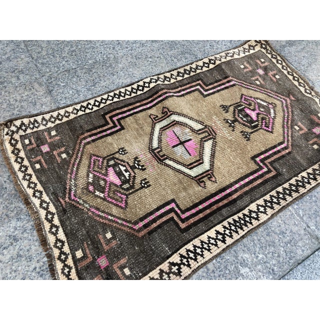 This is a vintage Turkish Oushak rug from the 1960s. The piece was hand-knotted.