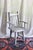 A unique wooden chair in a rustic or farmhouse style. Peg and dowel construction on the back with arm rests. Nail only...