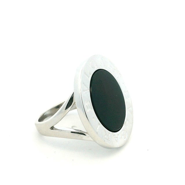 A bold Bulgari Bulgari ring crafted in 18K white gold and set with a large polished black onyx. The circular face is...