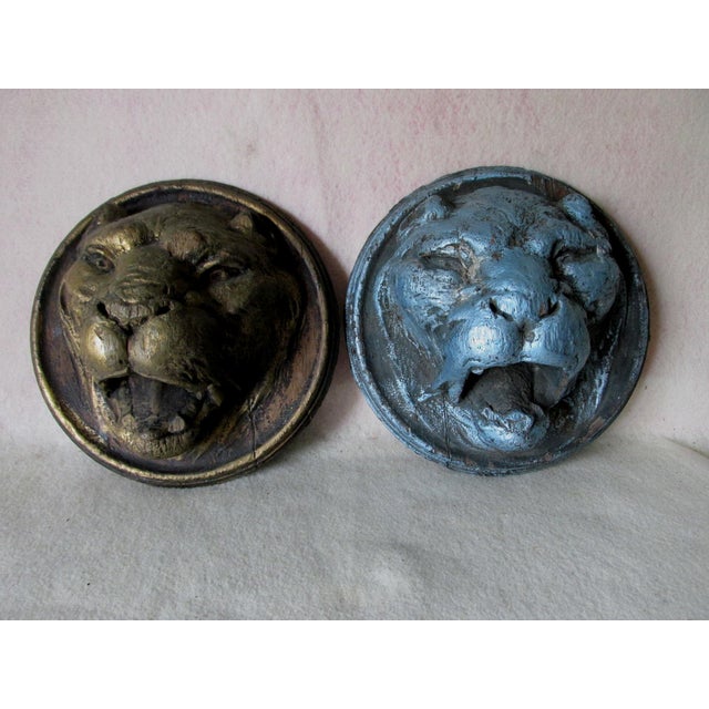 A pair of Antique (circa late 1800s) hand carved Architectural Lions. The Lions are hand carved wood, one is painted...
