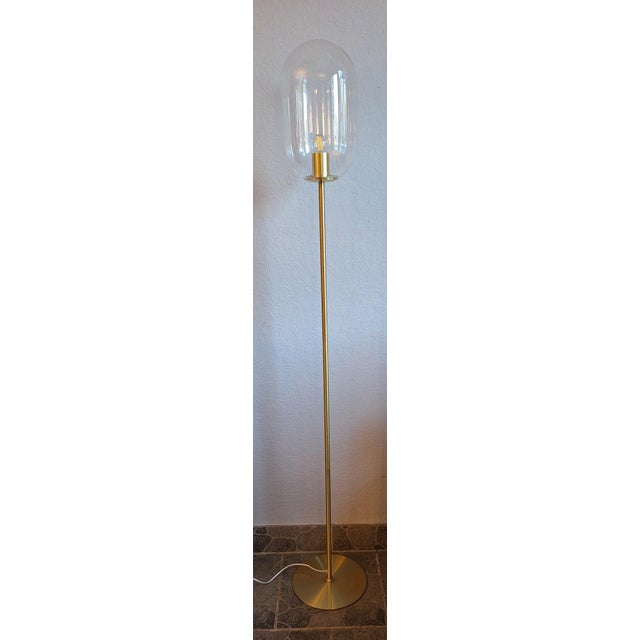 Vintage Floor Lamp with Brass Base and Clear Egg-Shaped Glass Shade, 2000s, in Very Good conditions. Designed from 2000...