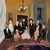 The Family Portrait is a modern impressionist artwork depicting several generations gathering for a formal portrait. The...