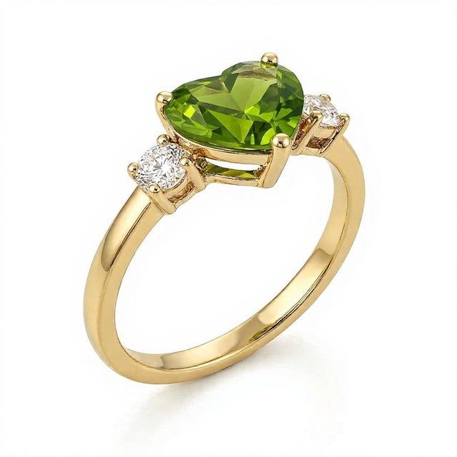 Peridot Heart Three-Stone Ring This elegant ring highlights the vibrant beauty of a peridot gemstone, designed with a...