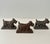 Three vintage cast iron Scottish terrier paperweights from Hamilton Foundry of Hamilton, Ohio. Each stands on an integral...