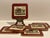A set of cork backed coasters bordered in dark red with scenes from the early 19th century coaching period featuring...