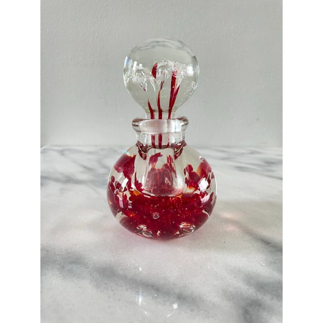 Beautiful red splash blown glass perfume bottle by Bill Knight, glass artists from Blenko. It features vibrant red...