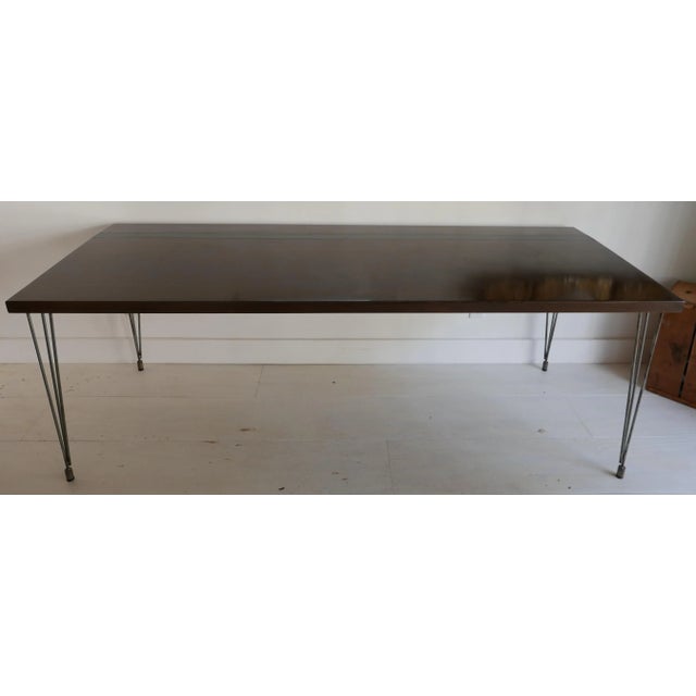 Statement dining table made of walnut with dark finish, black steel inset stripe. Super cool design. Patinaed raw steel legs.