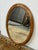Design Plus Gallery presents a Late 20th Century Oak Wood Wall Mirror. The mirror has a beveled edge and is encased in a...