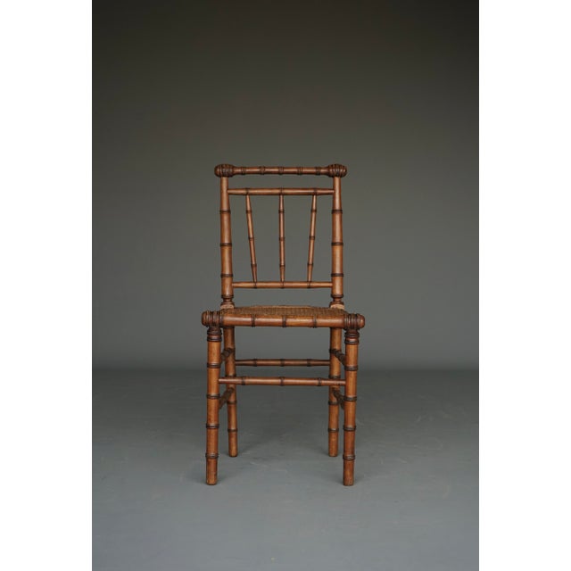 A stylish side chair made from beech wood that has been shaped to resemble bamboo. It has its original webbing seat.