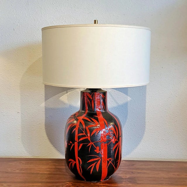 A large, black-and-red table lamp with a bamboo and peach blossom décor, designed in Italy in the 1960s by master potter...