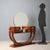 Art Deco dressing table with walnut veneer. Circular mirror, small glass shelf; front with a pair of drawers and a door....