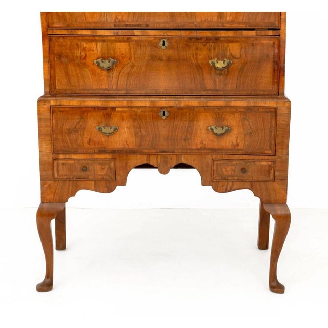 George II Feather-Banded and Walnut Chest on Stand, two short drawers above three long drawers and two small drawers above...