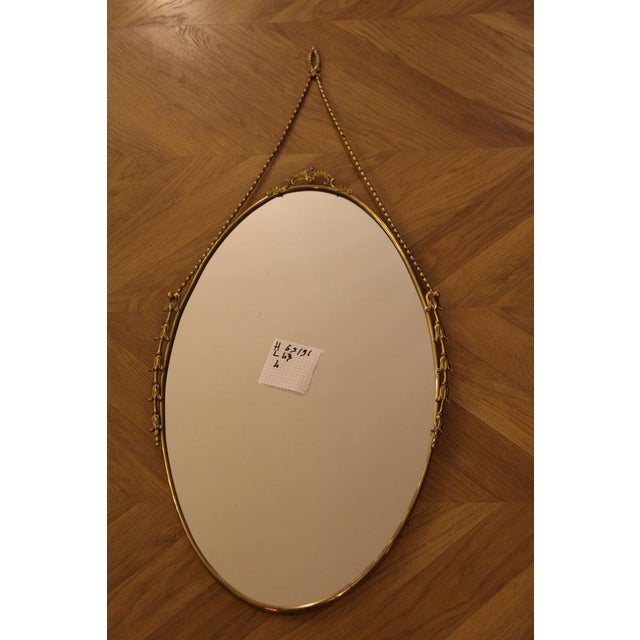 This highly decorative mirror was made in Italy in the 1950s. It is typical of the design of that period and is entirely...