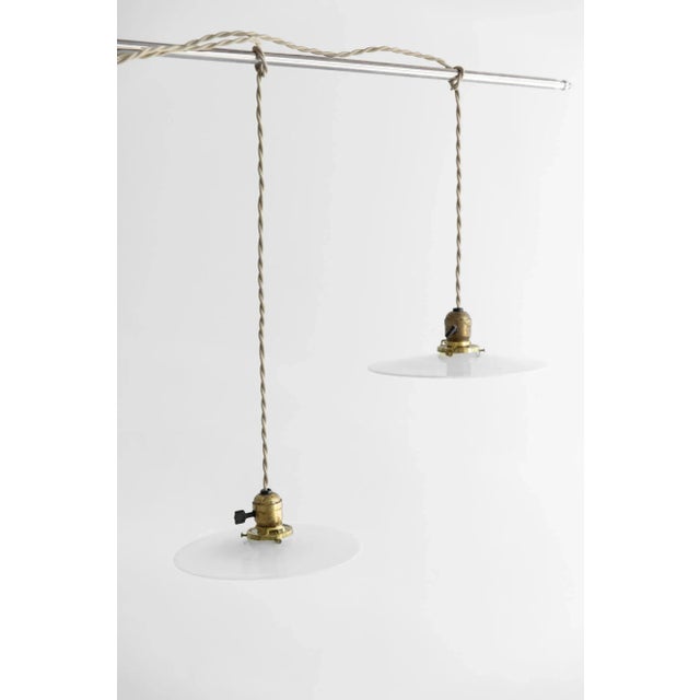 Pair of Vintage milk glass plug in light fixtures. Fabricated with brass fittings, khaki cotton double twist cord, and a...