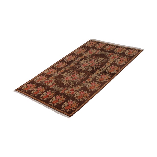 Hand-knotted in wool pile originating from Turkey circa 1950-1960, this vintage rug connotes a mid-century Bessarabian rug...