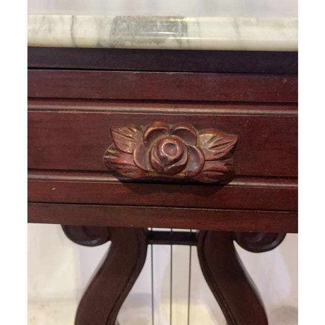 An exceptional and beautifully preserved pair of antique American Empire style mahogany parlor tables, dating to the late...