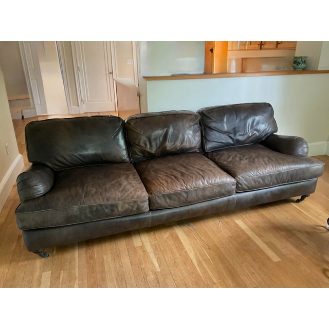 This is a Restoration Hardware distressed leather 96-inch sofa. I love the elegant rolling wheels, especially. The pillows...