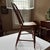 A hand-crafted chair — circa early 20th C. Farmhouse / rustic / primitive style. Windsor-style chair has bowed spindle...
