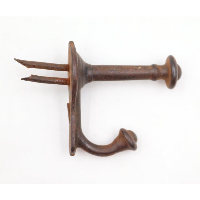 Antique cast iron double arm wall hooks with tack ends. Good condition with rusted surface wear from prior use. The nails...