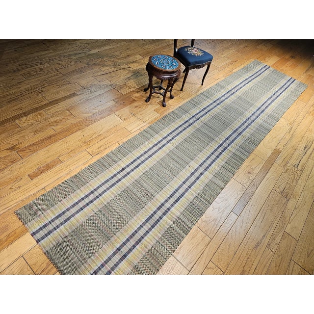 A charming and historically rich example of early American textile tradition, this Vintage American Amish Rag Runner dates...