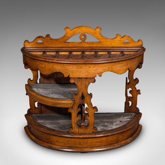 This is an antique country house estate hall stand. A Scottish, demi-lune oak umbrella rack, dating to the Victorian...
