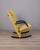 Rocking chair with metal and foam frame, yellow fabric upholstery, and black rubber legs and armrests. "T-Line" model,...