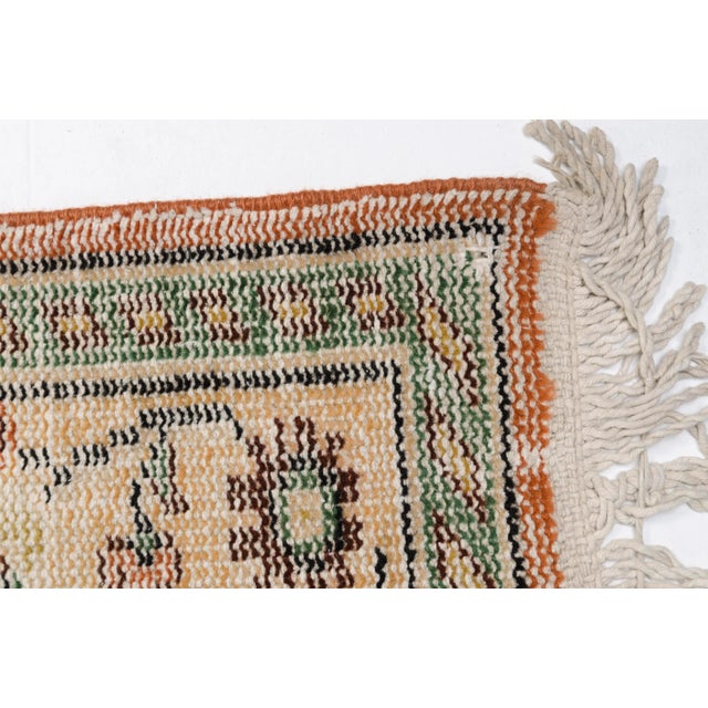 This is a vintage Turkish Oushak rug from the 1960s. The piece was hand-knotted.