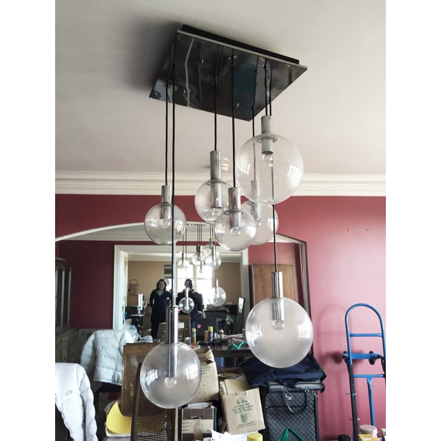 An eight pendant RAAK chandelier. Very nice scale for residential or office. The lamp hanging length can be modified...