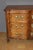 A Louis XV commode, known as a "crossbow" commode, with four drawers in three rows. One of the drawers conceals a secret...